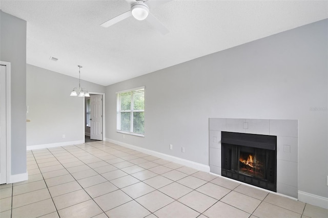 4870 S Semoran Blvd Unit 1905, Orlando, FL 32822 - unfurnished living room with lofted ceiling, ceiling fan, a tile fireplace, a chandelier, and baseboards