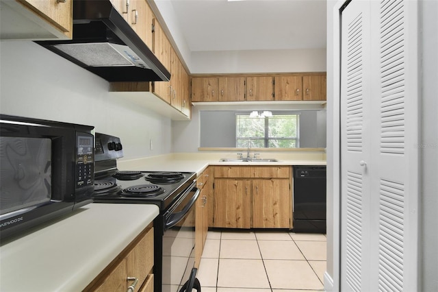 4870 S Semoran Blvd Unit 1905, Orlando, FL 32822 - kitchen featuring black appliances, ventilation hood, a sink, light countertops, and light tile patterned floors