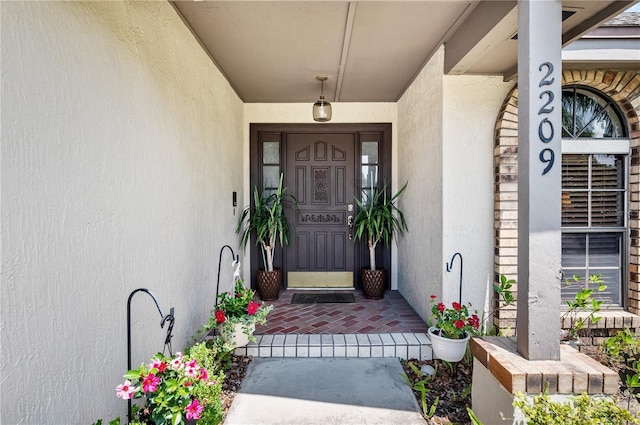 2209 Fairglenn Way, Winter Park, FL 32792 - view of exterior entry with stucco siding and a porch