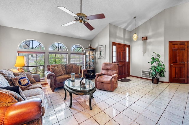 2209 Fairglenn Way, Winter Park, FL 32792 - living room featuring ceiling fan, high vaulted ceiling, a textured ceiling, light tile patterned floors, and baseboards