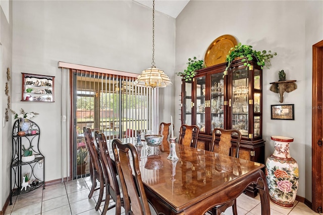 2209 Fairglenn Way, Winter Park, FL 32792 - dining area featuring high vaulted ceiling, a chandelier, light tile patterned floors, and baseboards