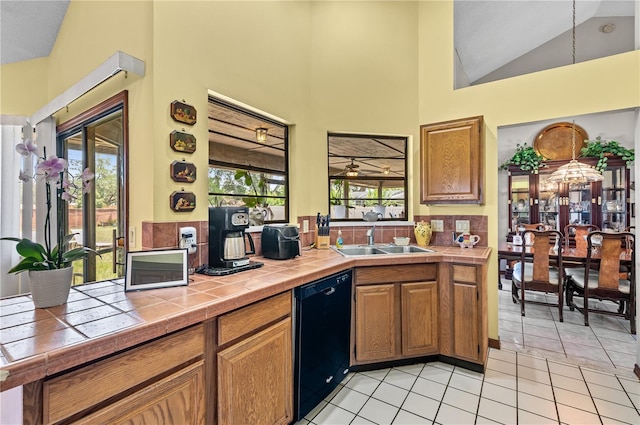 2209 Fairglenn Way, Winter Park, FL 32792 - kitchen with dishwasher, tile counters, a sink, light tile patterned flooring, and high vaulted ceiling