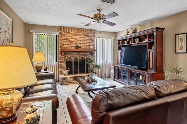 2209 Fairglenn Way, Winter Park, FL 32792 - tiled living room with a ceiling fan, a textured ceiling, and a brick fireplace