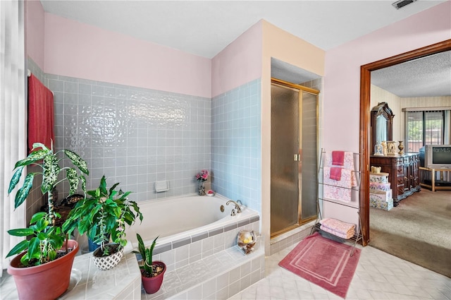 2209 Fairglenn Way, Winter Park, FL 32792 - bathroom with a bath, a stall shower, and tile patterned flooring