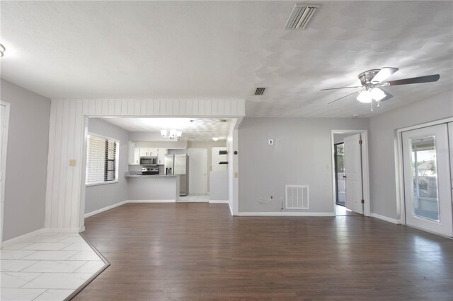 1668 Fort Smith Blvd, Deltona, FL 32725 - unfurnished living room with plenty of natural light, dark wood-type flooring, baseboards, and a ceiling fan