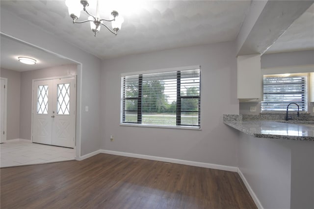 1668 Fort Smith Blvd, Deltona, FL 32725 - foyer with wood finished floors, a chandelier, and baseboards