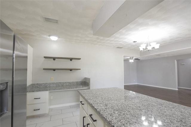 1668 Fort Smith Blvd, Deltona, FL 32725 - kitchen with stainless steel fridge, a chandelier, open shelves, and white cabinetry