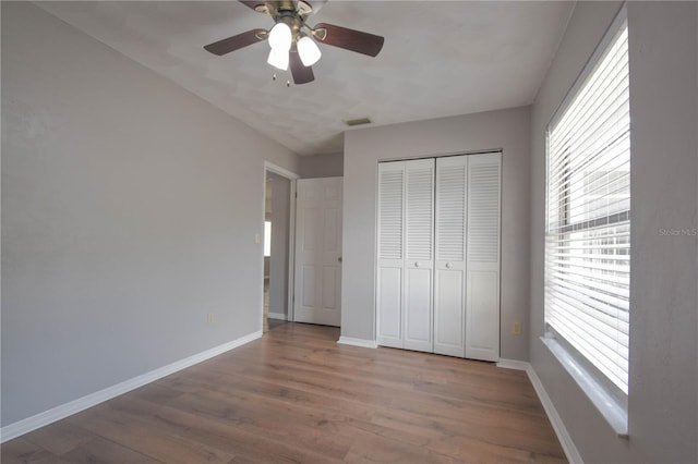 1668 Fort Smith Blvd, Deltona, FL 32725 - unfurnished bedroom featuring wood finished floors, baseboards, a closet, and a ceiling fan