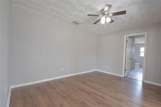 1668 Fort Smith Blvd, Deltona, FL 32725 - empty room with wood finished floors, a ceiling fan, and baseboards