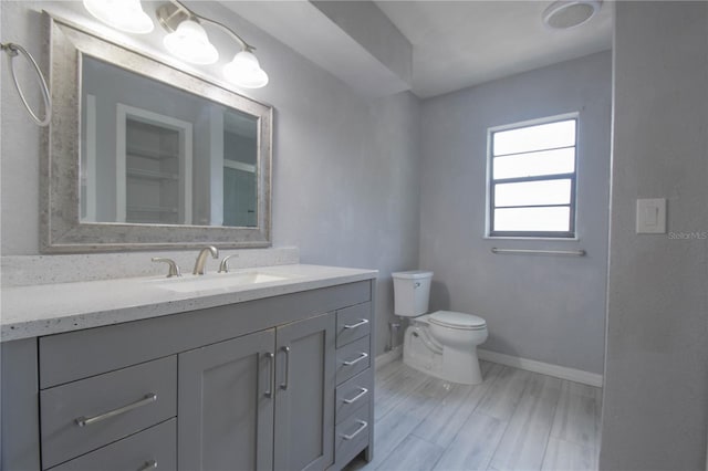 1668 Fort Smith Blvd, Deltona, FL 32725 - bathroom featuring baseboards, vanity, toilet, and wood finished floors