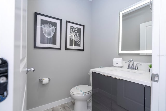 4414 Le Reve Ct, Kissimmee, FL 34746 - bathroom featuring toilet, vanity, wood finished floors, and baseboards