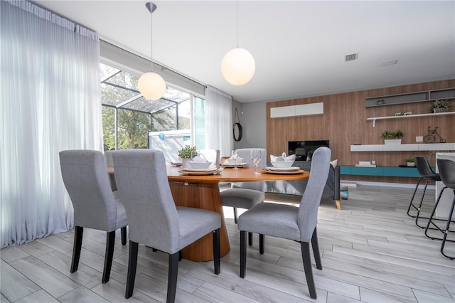 4414 Le Reve Ct, Kissimmee, FL 34746 - dining space with wooden walls and light wood finished floors