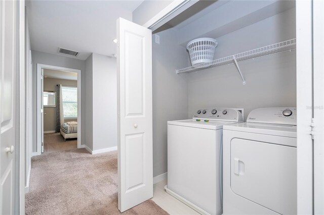 4414 Le Reve Ct, Kissimmee, FL 34746 - washroom featuring washer and clothes dryer, light carpet, and baseboards