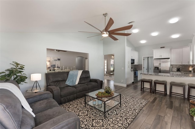 2122 Palm Crest Dr, Apopka, FL 32712 - living area with a ceiling fan, dark wood-style flooring, high vaulted ceiling, and baseboards