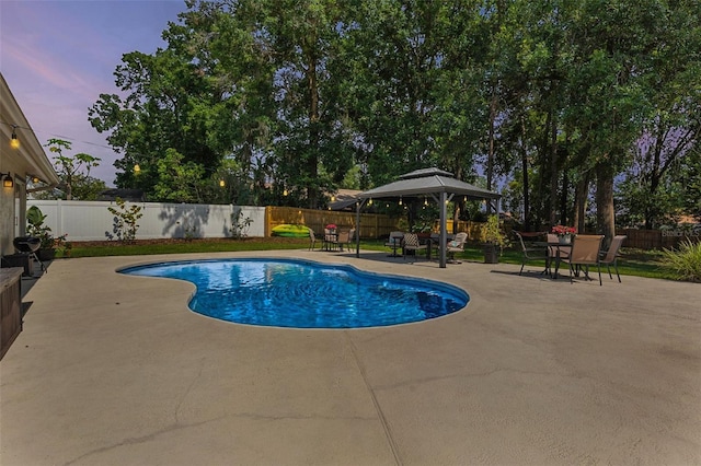 2122 Palm Crest Dr, Apopka, FL 32712 - pool at dusk featuring a patio, a gazebo, a fenced backyard, and outdoor dining area