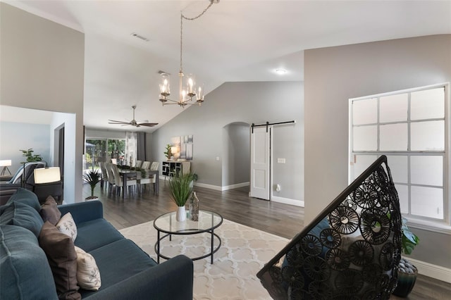 2122 Palm Crest Dr, Apopka, FL 32712 - living room featuring arched walkways, wood finished floors, a chandelier, a barn door, and baseboards