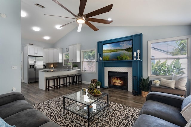 2122 Palm Crest Dr, Apopka, FL 32712 - living area featuring a ceiling fan, lofted ceiling, dark wood-type flooring, and a tile fireplace