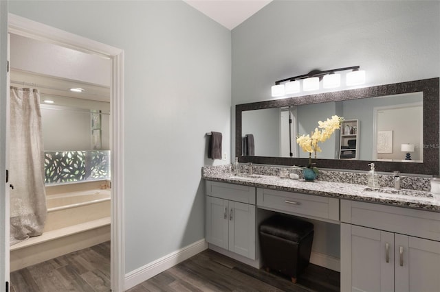 2122 Palm Crest Dr, Apopka, FL 32712 - full bath featuring wood finished floors, double vanity, a bath, and baseboards