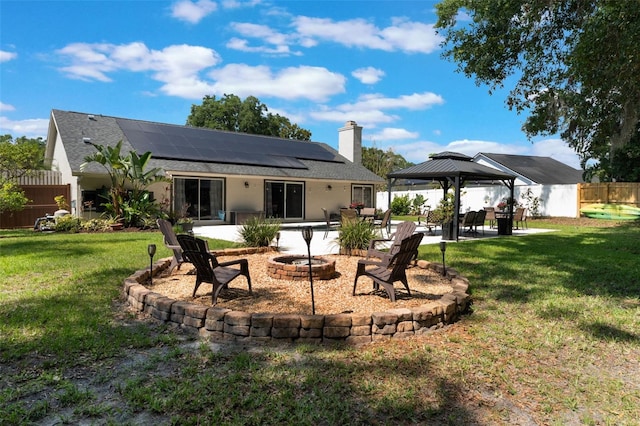 2122 Palm Crest Dr, Apopka, FL 32712 - back of house featuring an outdoor fire pit, a gazebo, a patio, solar panels, and a chimney