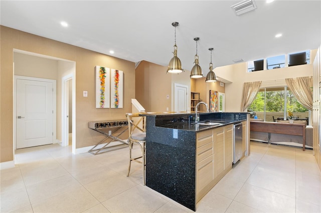 3149 Brasilia Ave, Kissimmee, FL 34747 - kitchen featuring a kitchen island with sink, recessed lighting, a kitchen breakfast bar, light tile patterned floors, and stainless steel dishwasher