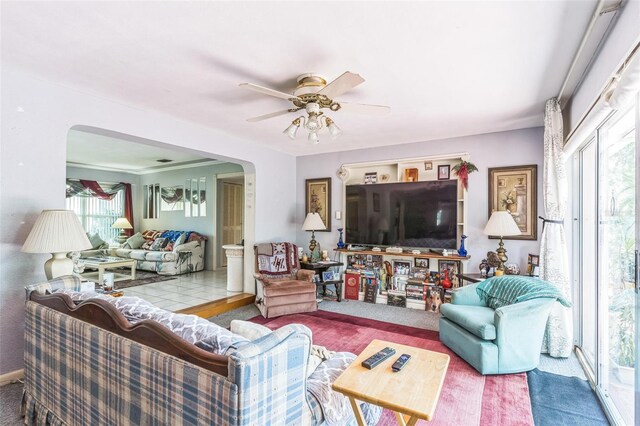 251 Tropic Blvd W, Largo, FL 33770 - carpeted living area featuring arched walkways, healthy amount of natural light, and a ceiling fan
