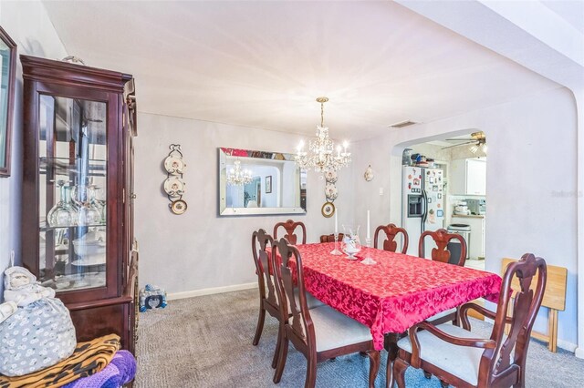 251 Tropic Blvd W, Largo, FL 33770 - carpeted dining area featuring a chandelier, baseboards, arched walkways, and a ceiling fan