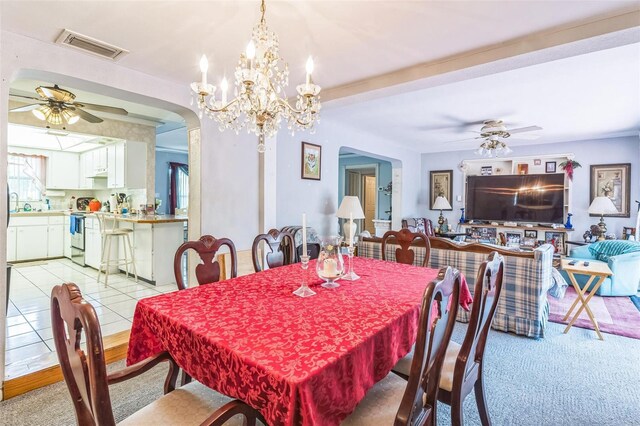 251 Tropic Blvd W, Largo, FL 33770 - dining space featuring a ceiling fan, arched walkways, light carpet, and a chandelier