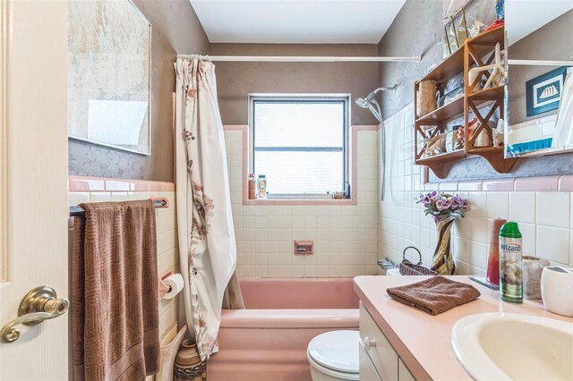 251 Tropic Blvd W, Largo, FL 33770 - full bathroom with tile walls, shower / tub combo, vanity, toilet, and a wainscoted wall