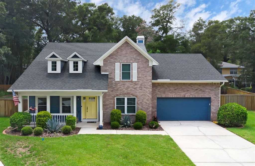 1610 Owl Ridge Ct, Apopka, FL 32712 - traditional-style home with roof with shingles, a chimney, and concrete driveway