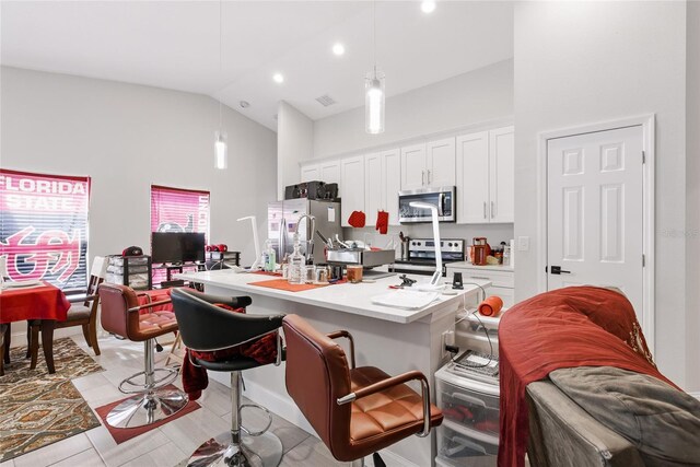 999 Trumbull St, Deltona, FL 32725 - kitchen featuring appliances with stainless steel finishes, high vaulted ceiling, open floor plan, a breakfast bar area, and white cabinetry