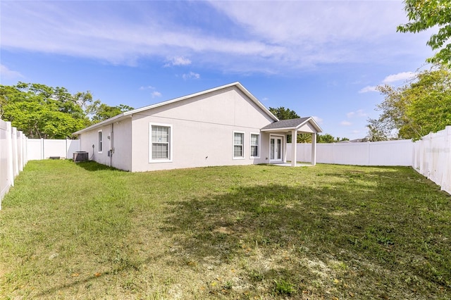 999 Trumbull St, Deltona, FL 32725 - rear view of house featuring central air condition unit and stucco siding