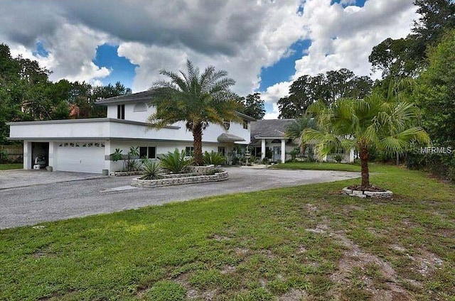 18620 Wayne Rd, Odessa, FL 33556 - view of front facade with driveway, a garage, and a front yard