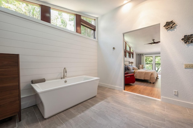 20 Twelve Oaks Trl, Ormond Beach, FL 32174 - ensuite bathroom with a soaking tub, ceiling fan, baseboards, and a textured wall
