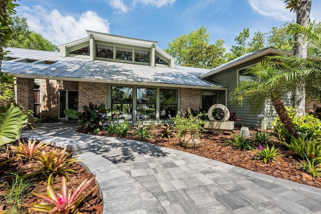 20 Twelve Oaks Trl, Ormond Beach, FL 32174 - view of front of home with brick siding, metal roof, and a standing seam roof