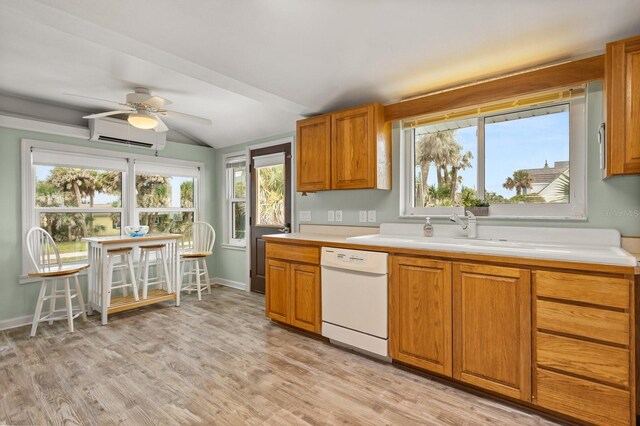 4039 S Atlantic Ave, Port Orange, FL 32127 - kitchen with white dishwasher, a wall mounted air conditioner, light countertops, brown cabinets, and light wood finished floors