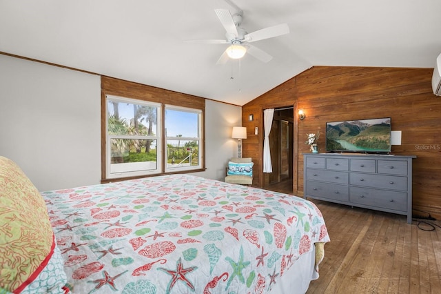 4039 S Atlantic Ave, Port Orange, FL 32127 - bedroom with wood walls, vaulted ceiling, hardwood / wood-style floors, and a ceiling fan