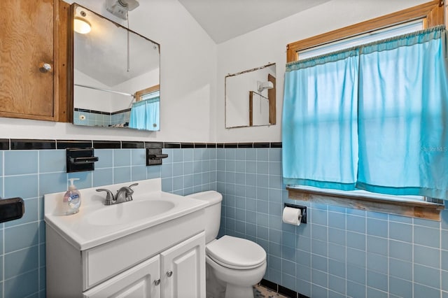 4039 S Atlantic Ave, Port Orange, FL 32127 - full bath featuring plenty of natural light, tile walls, vanity, a wainscoted wall, and a shower with curtain