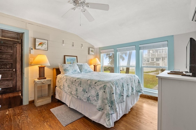 4039 S Atlantic Ave, Port Orange, FL 32127 - bedroom with wood finished floors, lofted ceiling, a wall mounted air conditioner, and a ceiling fan