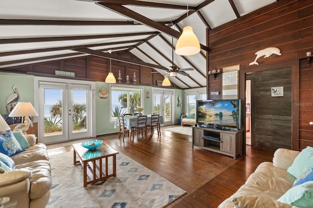 4039 S Atlantic Ave, Port Orange, FL 32127 - living area with wooden walls, beamed ceiling, a ceiling fan, wood finished floors, and high vaulted ceiling
