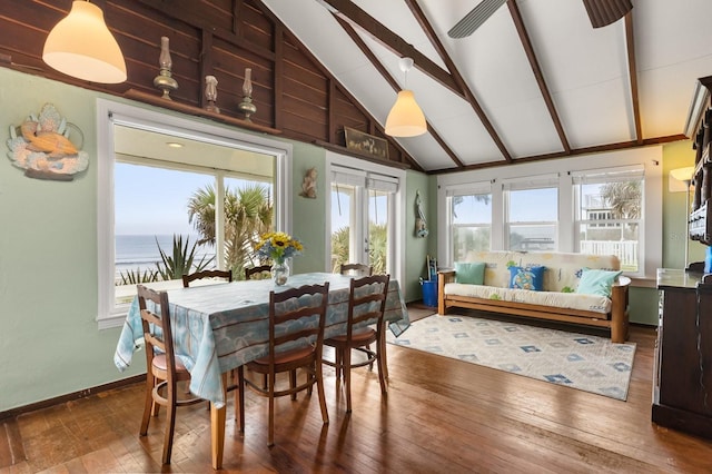 4039 S Atlantic Ave, Port Orange, FL 32127 - dining space featuring wood-type flooring, beamed ceiling, high vaulted ceiling, and a water view