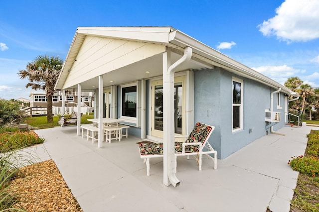 4039 S Atlantic Ave, Port Orange, FL 32127 - rear view of property with a patio and stucco siding