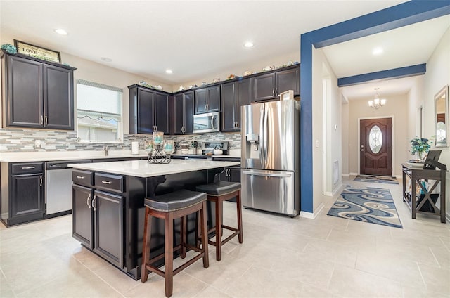 3349 Sagebrush St, Harmony, FL 34773 - kitchen featuring stainless steel appliances, backsplash, plenty of natural light, a breakfast bar area, and recessed lighting