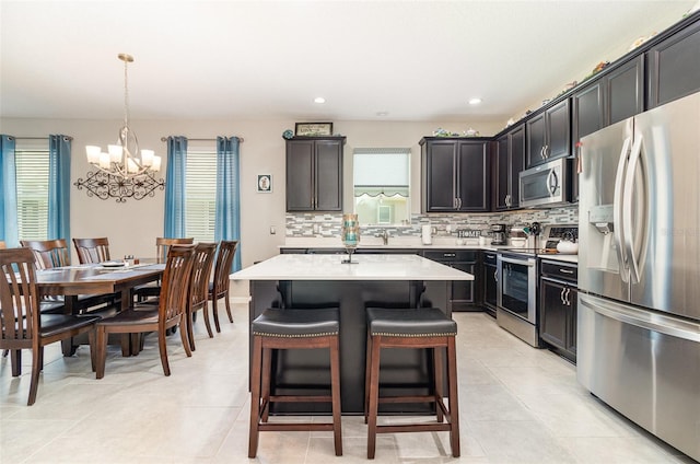 3349 Sagebrush St, Harmony, FL 34773 - kitchen with stainless steel appliances, a chandelier, plenty of natural light, decorative backsplash, and recessed lighting