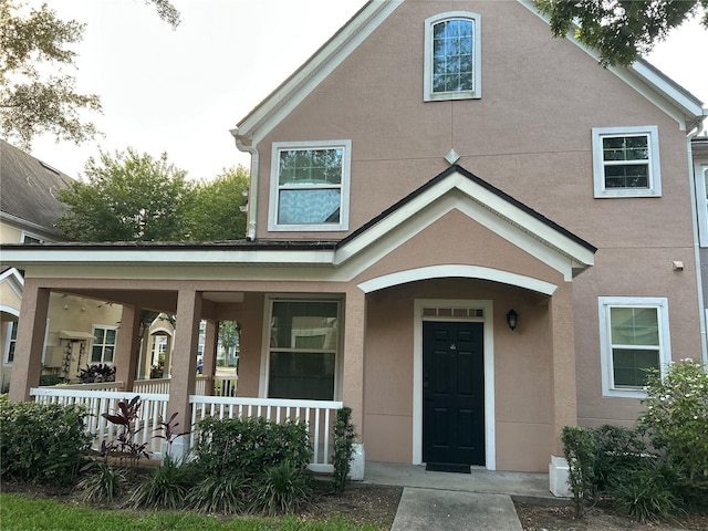 3417 Westchester Square Blvd Unit 202, Orlando, FL 32835 - view of front of house featuring a porch and stucco siding
