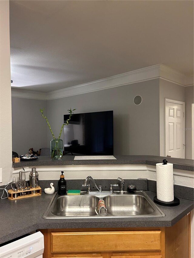 3417 Westchester Square Blvd Unit 202, Orlando, FL 32835 - kitchen featuring a sink, dark countertops, white dishwasher, crown molding, and brown cabinets