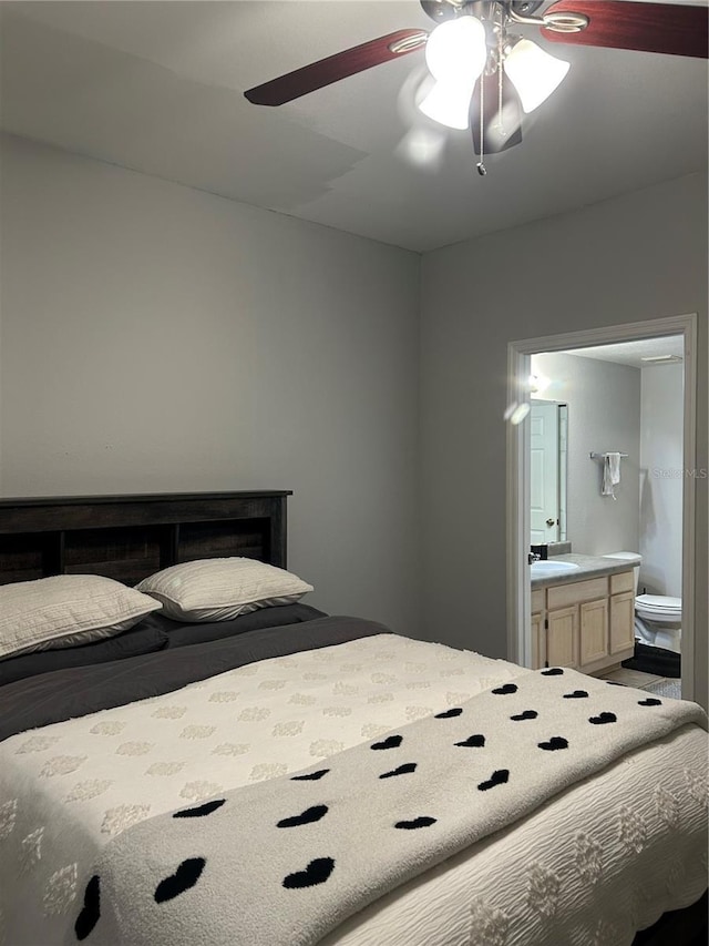 3417 Westchester Square Blvd Unit 202, Orlando, FL 32835 - bedroom with ensuite bath, a ceiling fan, and a sink