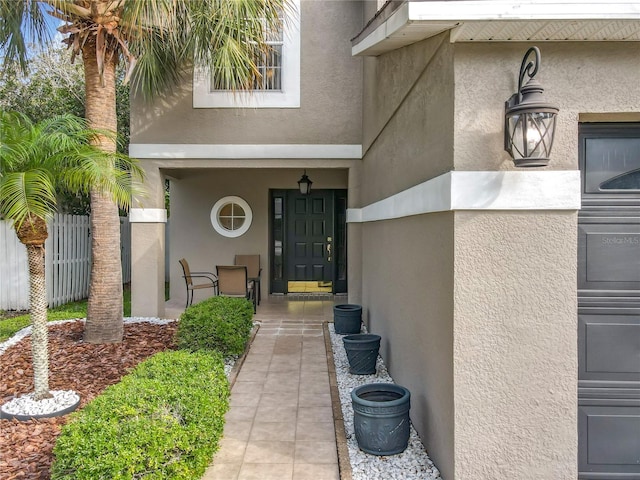 1803 Meadow Pond Way, Orlando, FL 32824 - view of exterior entry featuring stucco siding and a porch