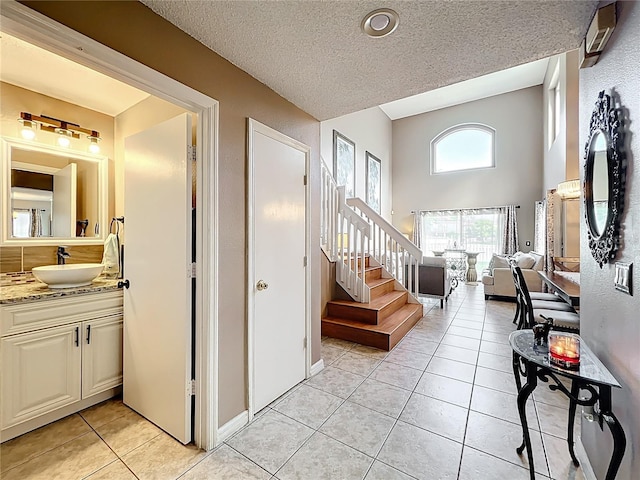 1803 Meadow Pond Way, Orlando, FL 32824 - staircase featuring a textured ceiling, tile patterned floors, and vaulted ceiling