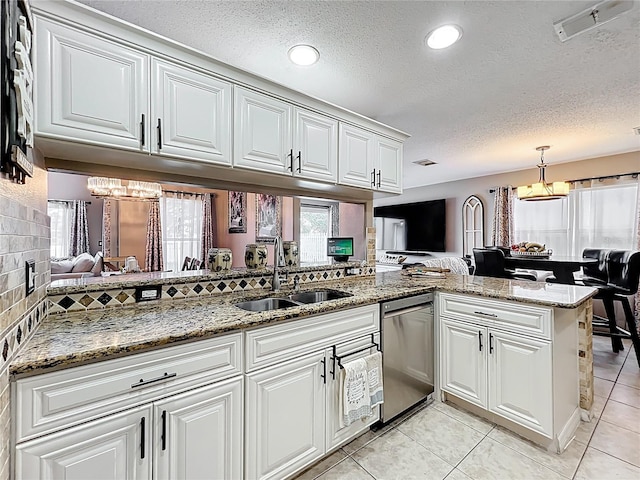 1803 Meadow Pond Way, Orlando, FL 32824 - kitchen featuring dishwasher, a sink, a chandelier, a textured ceiling, and white cabinets