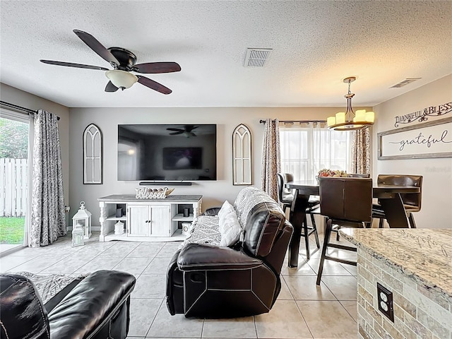 1803 Meadow Pond Way, Orlando, FL 32824 - living area with a chandelier, a textured ceiling, light tile patterned floors, and ceiling fan